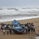 Fishermen move a fishing boat to a safer place along the shore ahead of cyclone Hudhud at Ganjam district in Odisha.